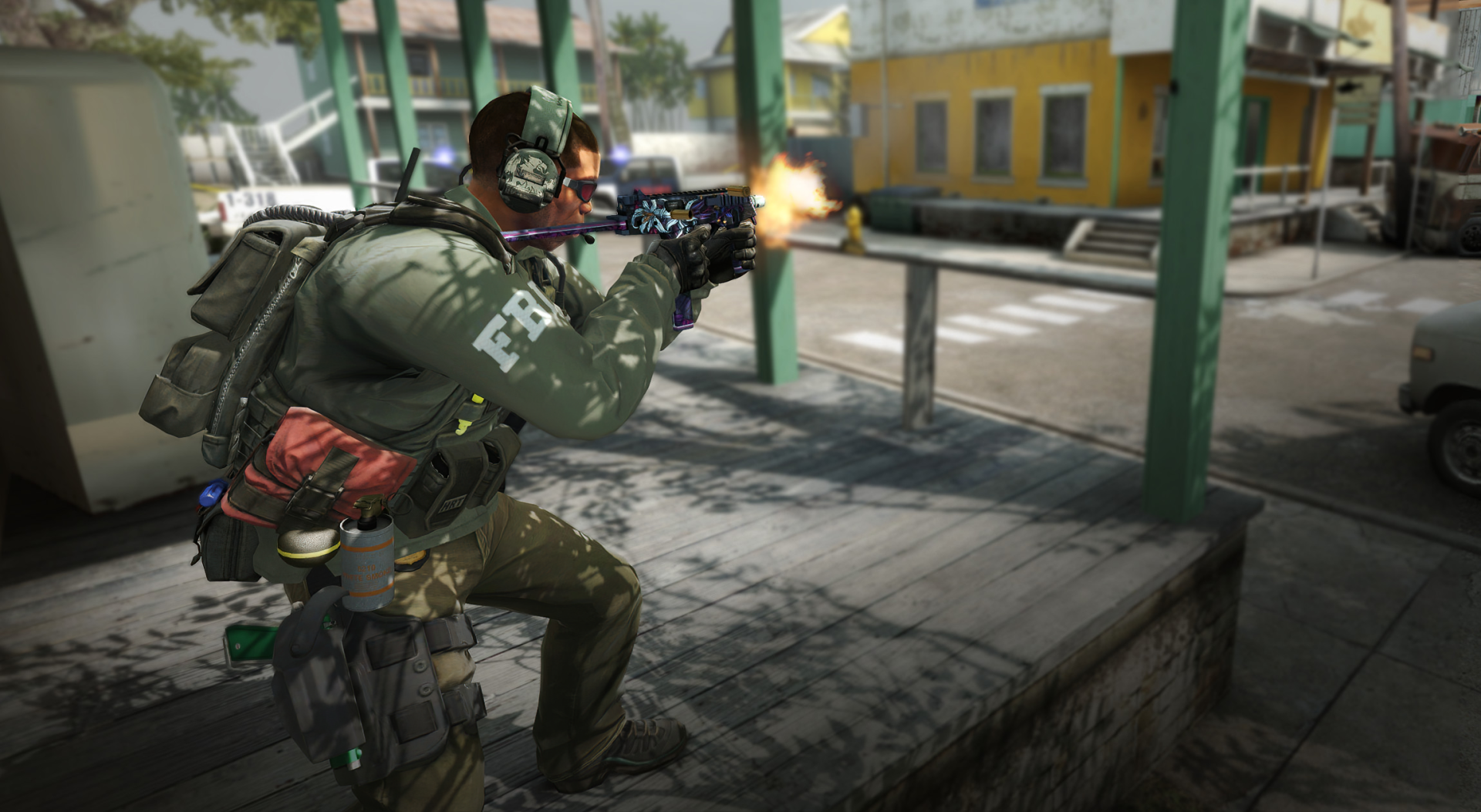 A soldier in tactical gear fires a weapon in a vibrant urban scene, representing intense gameplay in Counter-Strike 2. This high-definition image serves as a striking desktop wallpaper.