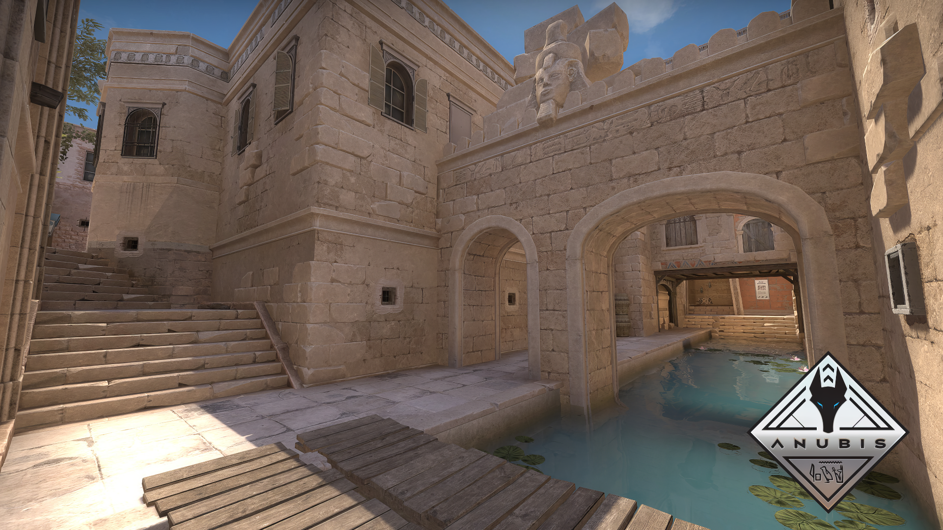 HD desktop wallpaper of a Counter-Strike 2 game map, featuring an ancient Anubis-themed architecture with stone structures and a serene water pool.