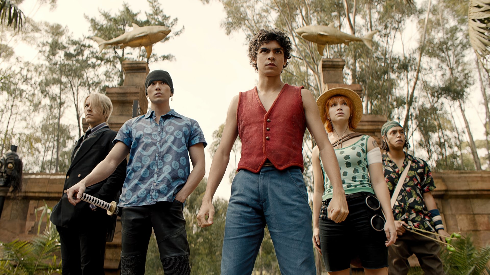 HD desktop wallpaper of One Piece live-action TV show featuring the main characters standing confidently outdoors, suitable as a vibrant background.