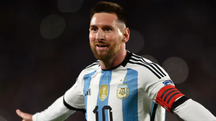 HD desktop wallpaper featuring Lionel Messi in the Argentina National Football Team kit, expressing joy during a match.