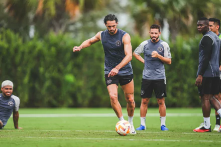 Inter Miami CF player demonstrates ball control during training on a lush green field, with teammates in the background, in a vibrant HD desktop wallpaper and background.