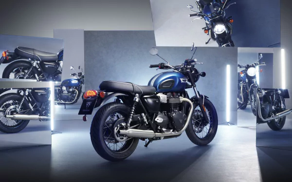 Triumph Bonneville T100 Chrome Edition motorcycles showcased as HD desktop wallpaper in a modern showroom setting.