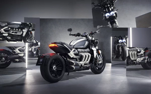 HD wallpaper featuring the sleek Triumph Rocket III in its Chrome Edition, perfectly posed in a stylish showroom setting alongside the formidable Triumph Rocket III R model.