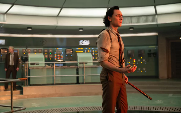 HD desktop wallpaper featuring the character Loki from Marvel Comics, portrayed by Tom Hiddleston, standing thoughtfully in a futuristic setting.
