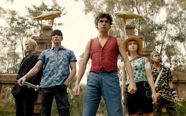 HD desktop wallpaper of One Piece live-action TV show featuring the main characters standing confidently outdoors, suitable as a vibrant background.
