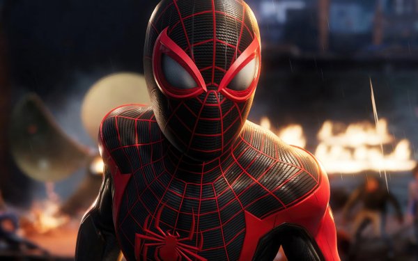 HD desktop wallpaper featuring Miles Morales as Spider-Man from Marvel's Spider-Man 2 game, showcasing the iconic red and black suit with a dynamic pose against a blurred cityscape background.