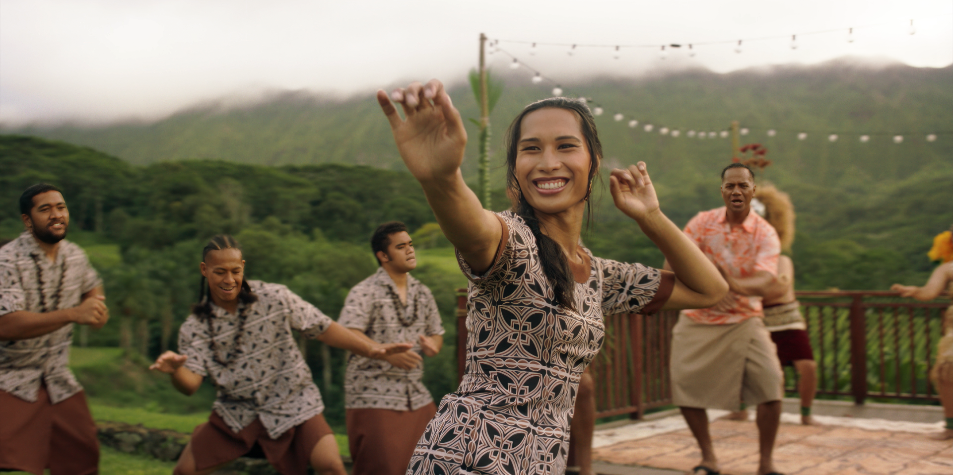 HD wallpaper of a joyful dance scene from Next Goal Wins (2023) with a group of people celebrating outdoors.