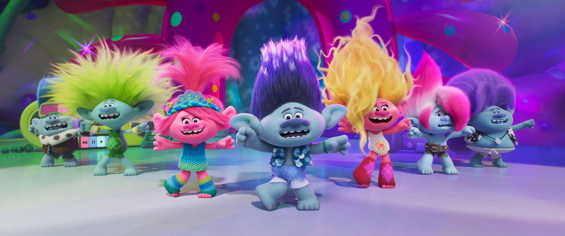 Colorful characters from the movie Trolls Band Together dance joyfully, showcasing vibrant hairstyles and playful expressions in this lively HD desktop wallpaper.