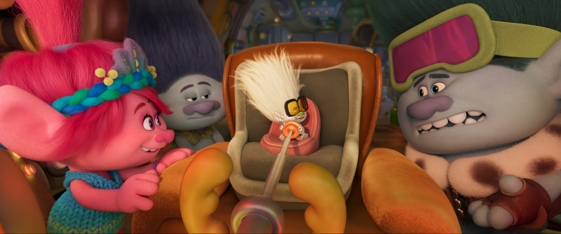 A vibrant HD desktop wallpaper from Trolls Band Together, featuring colorful Troll characters interacting with a quirky, anthropomorphic object in a cozy setting.