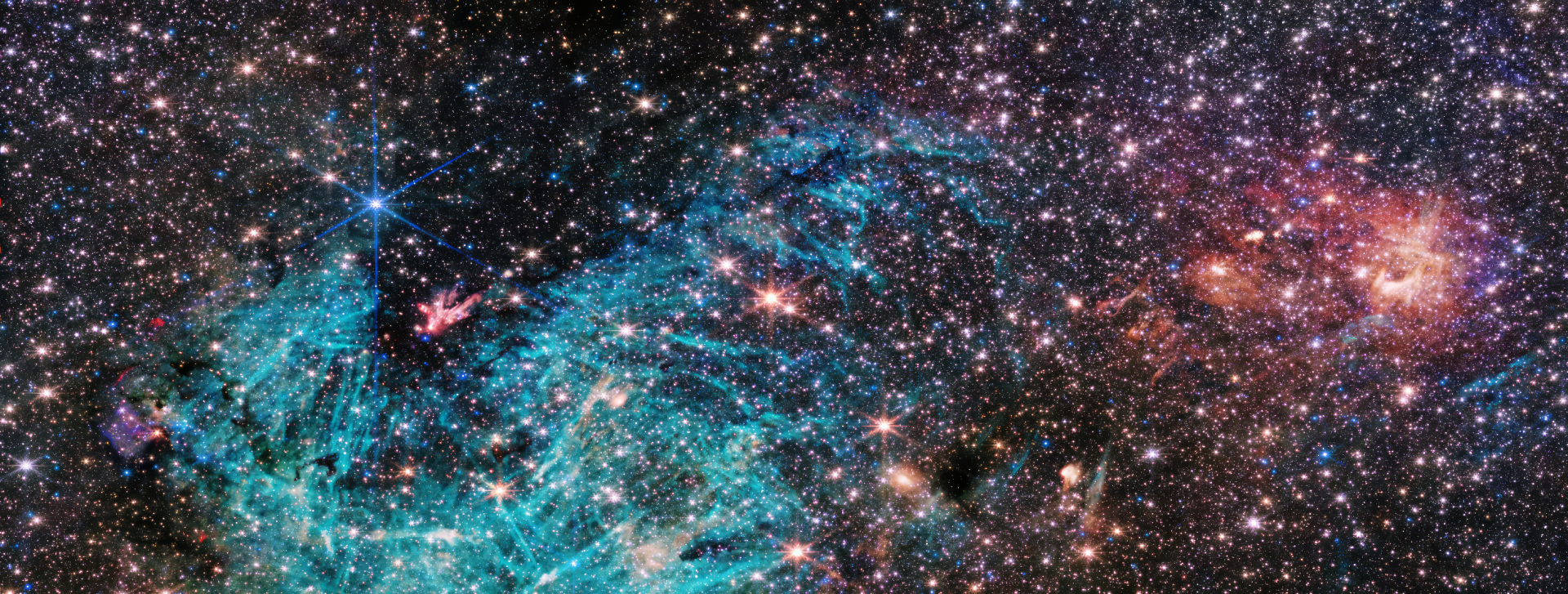 HD desktop wallpaper of a vibrant galaxy captured by the James Webb Space Telescope, featuring a multitude of stars and cosmic dust.