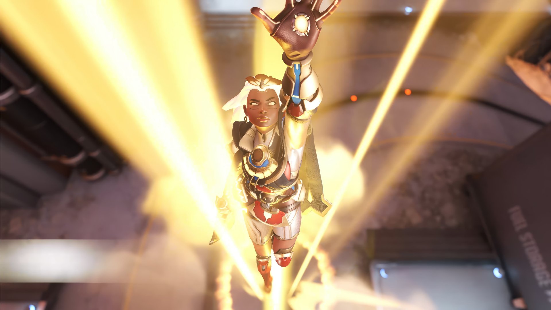 Illari from Overwatch 2 is depicted soaring upward, illuminated by vibrant beams of light, creating a striking HD desktop wallpaper and background for gamers.