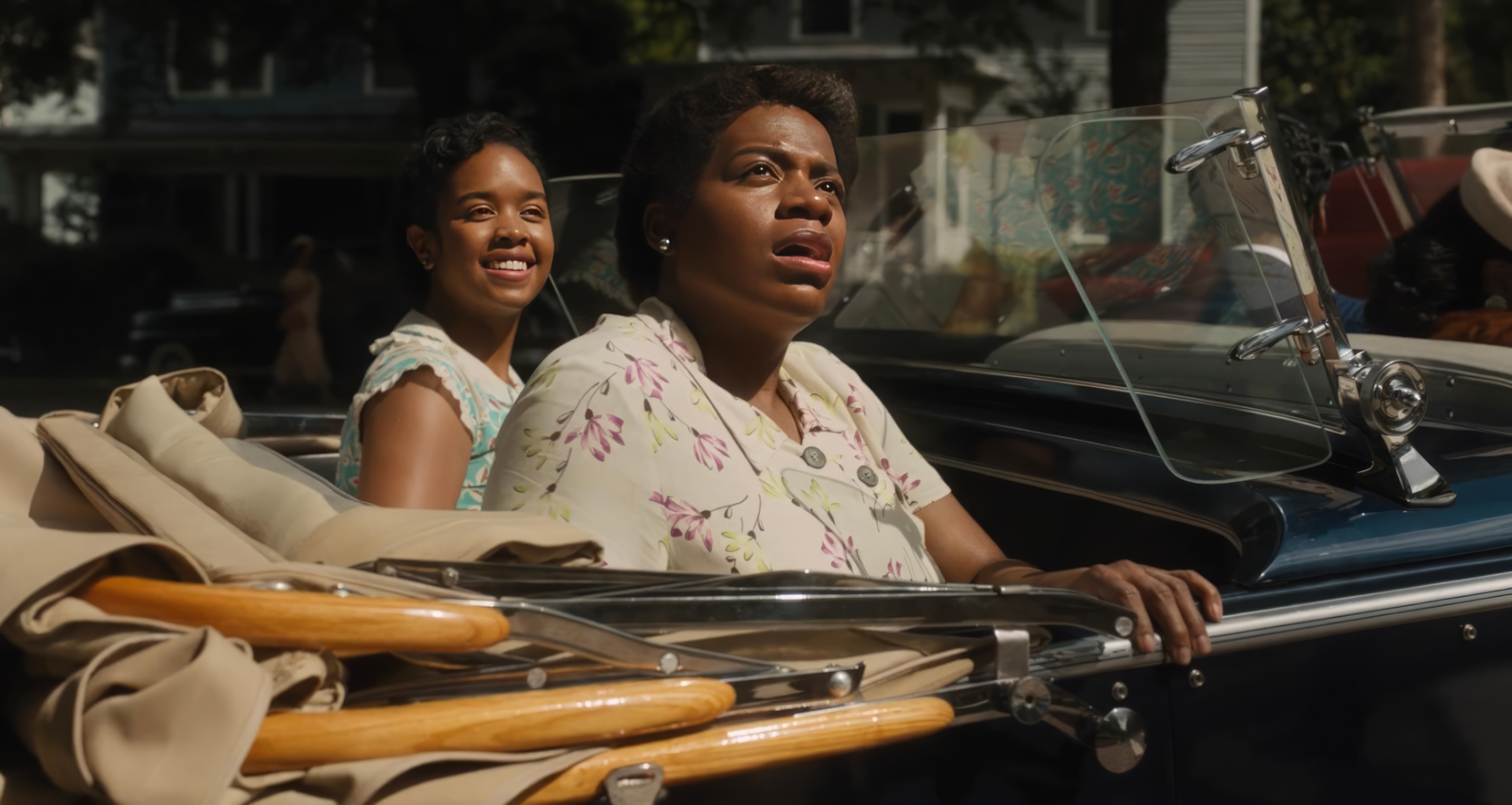HD wallpaper featuring a scene from The Color Purple 2023 movie with two characters in a vintage car.