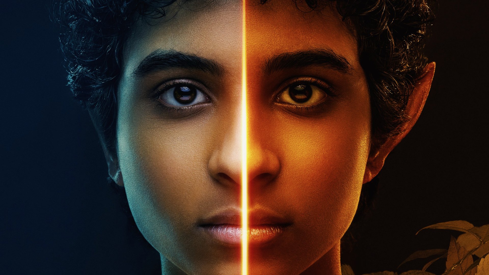 HD PC desktop wallpaper featuring a split close-up of a character from the TV show Percy Jackson and the Olympians, highlighting contrasting light and shadow.