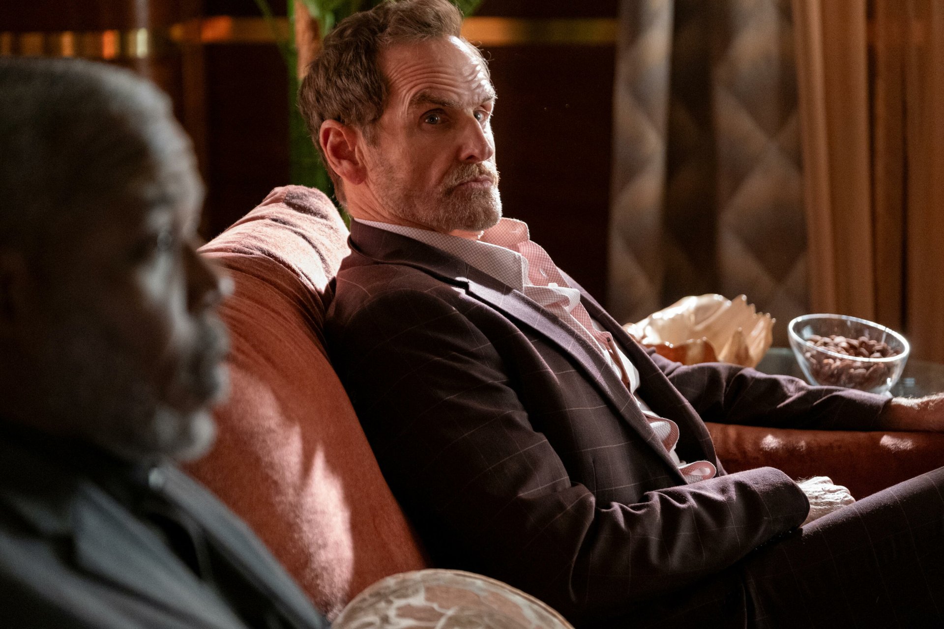 HD wallpaper featuring two characters from a TV show sitting on a sofa, with themes of death and mystery for desktop background.