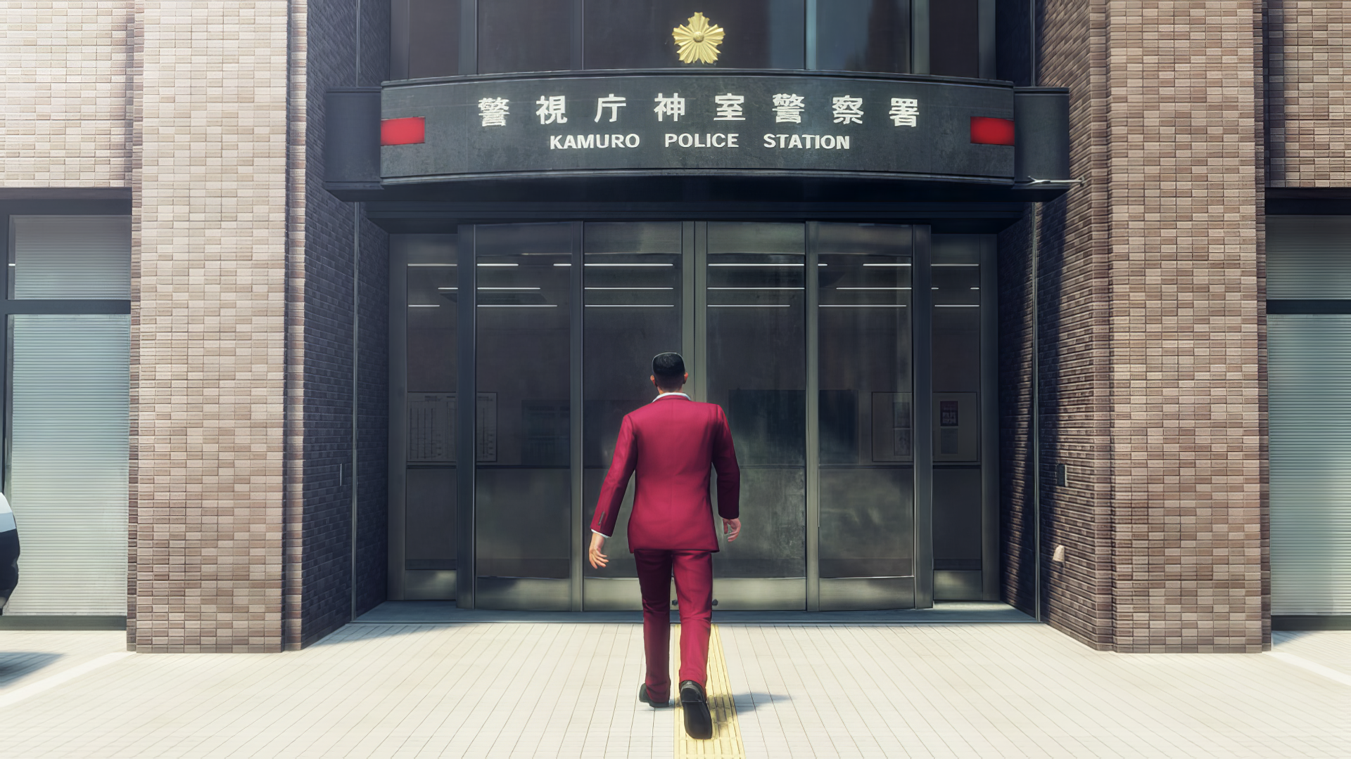 HD wallpaper featuring a character from 'Yakuza: Like a Dragon' approaching the Kamuro Police Station.