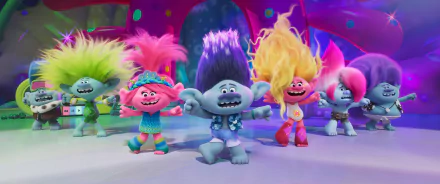 Colorful characters from the movie Trolls Band Together dance joyfully, showcasing vibrant hairstyles and playful expressions in this lively HD desktop wallpaper.