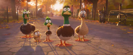 HD wallpaper of animated ducks from the movie Migration (2023) standing on a sunlit path with autumn trees in the background.