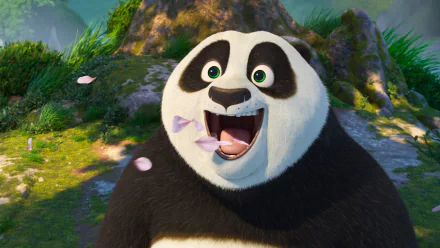 HD desktop wallpaper of Po from Kung Fu Panda 4, excitedly posing in a serene outdoor setting with falling petals.