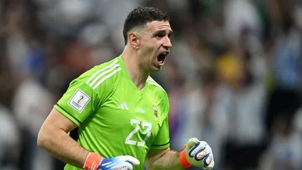 HD desktop wallpaper featuring a goalkeeper in action, dressed in the Argentina National Football Team uniform, on the soccer field.
