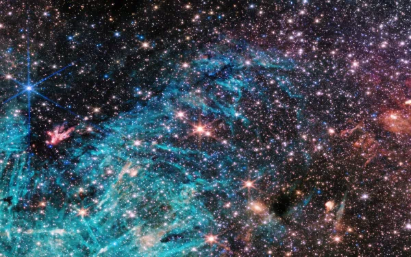 HD desktop wallpaper of a vibrant galaxy captured by the James Webb Space Telescope, featuring a multitude of stars and cosmic dust.
