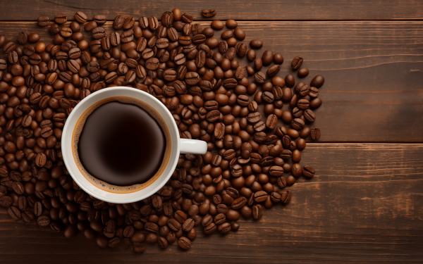 HD wallpaper featuring a cup of coffee surrounded by coffee beans on a wooden surface.