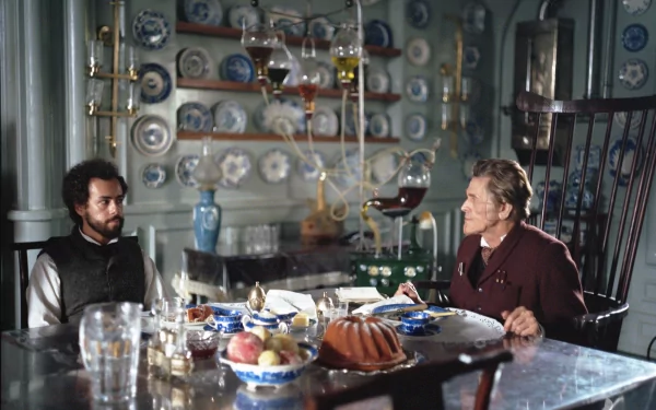 HD wallpaper of a scene from the movie Poor Things featuring two characters seated at a dining table with vintage decor.