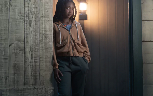 HD desktop wallpaper of a character from Percy Jackson and the Olympians standing confidently in a dimly lit hallway.