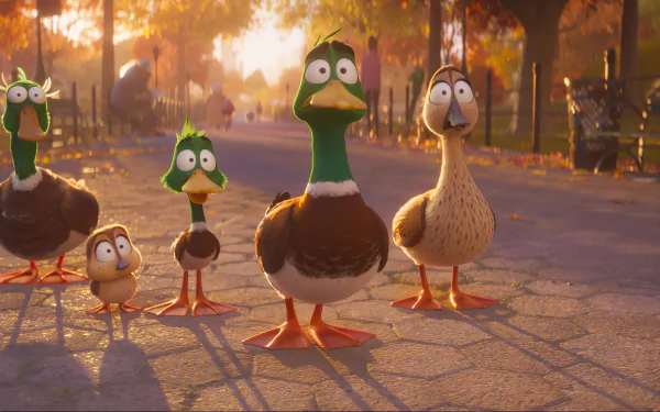 HD wallpaper of animated ducks from the movie Migration (2023) standing on a sunlit path with autumn trees in the background.