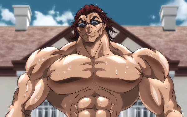 HD anime wallpaper featuring the muscular character Baki Hanma from the series 'Baki the Grappler' standing confidently with a building in the background.
