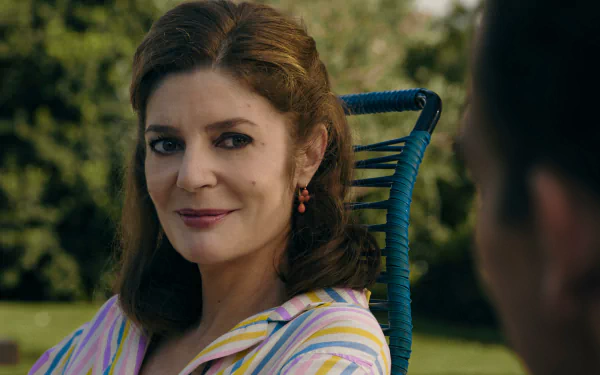 Image from the TV show Monsieur Spade featuring a woman in a striped outfit sitting in a wicker chair, providing a high-definition desktop wallpaper or background.