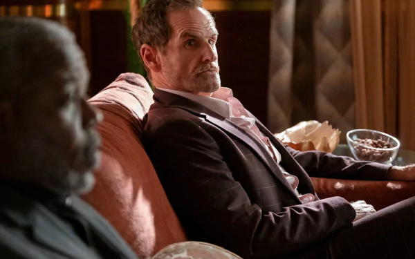 HD wallpaper featuring two characters from a TV show sitting on a sofa, with themes of death and mystery for desktop background.