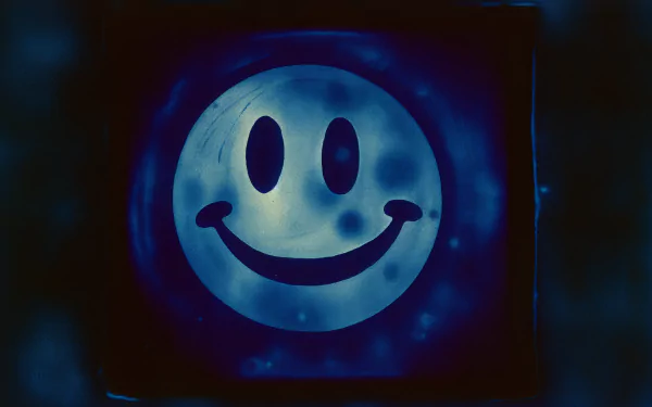 A vibrant HD desktop wallpaper featuring a classic smiley face against a blue background, exuding a cheerful and uplifting vibe.