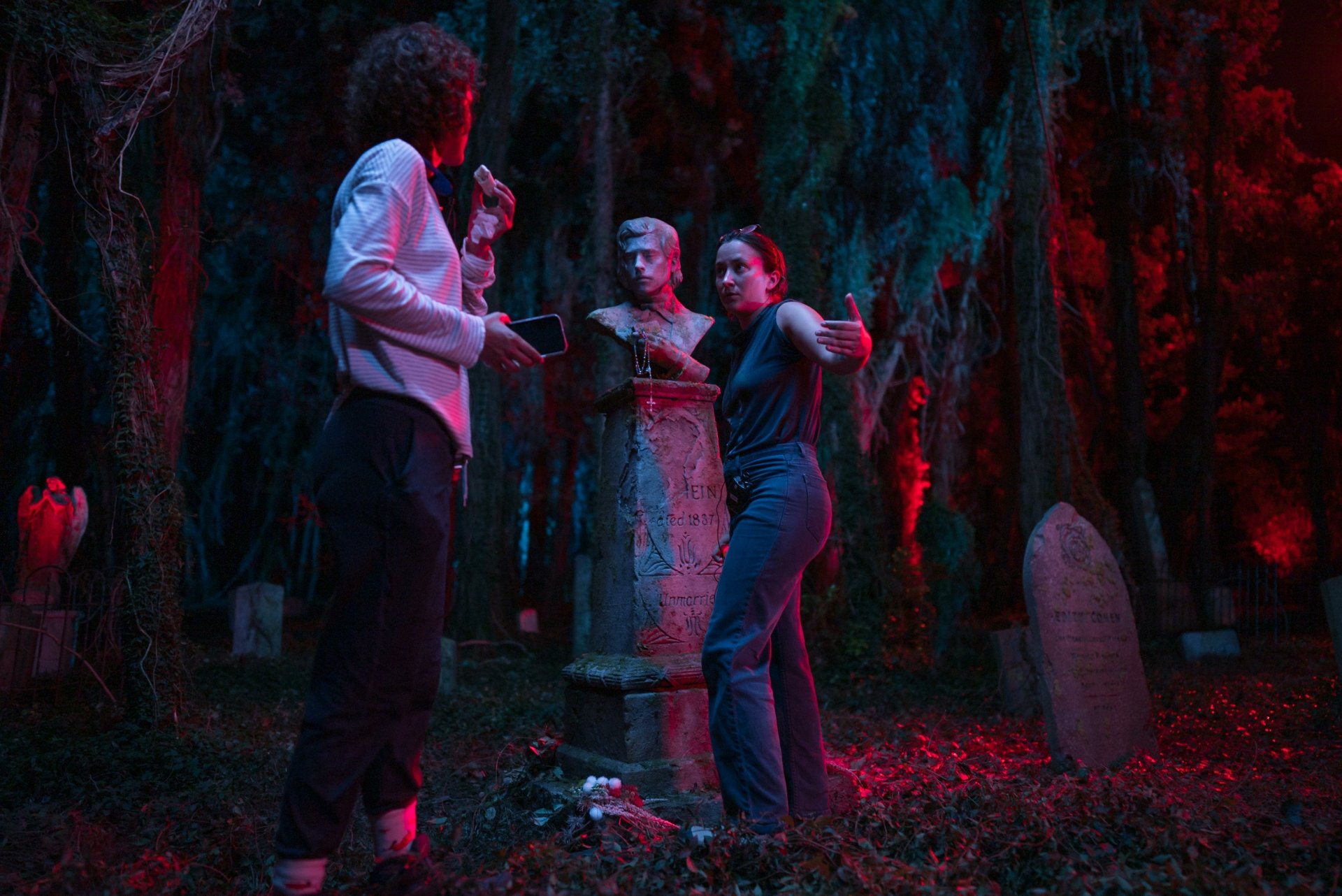 HD desktop wallpaper from the movie Lisa Frankenstein featuring characters in a neon-lit graveyard scene.