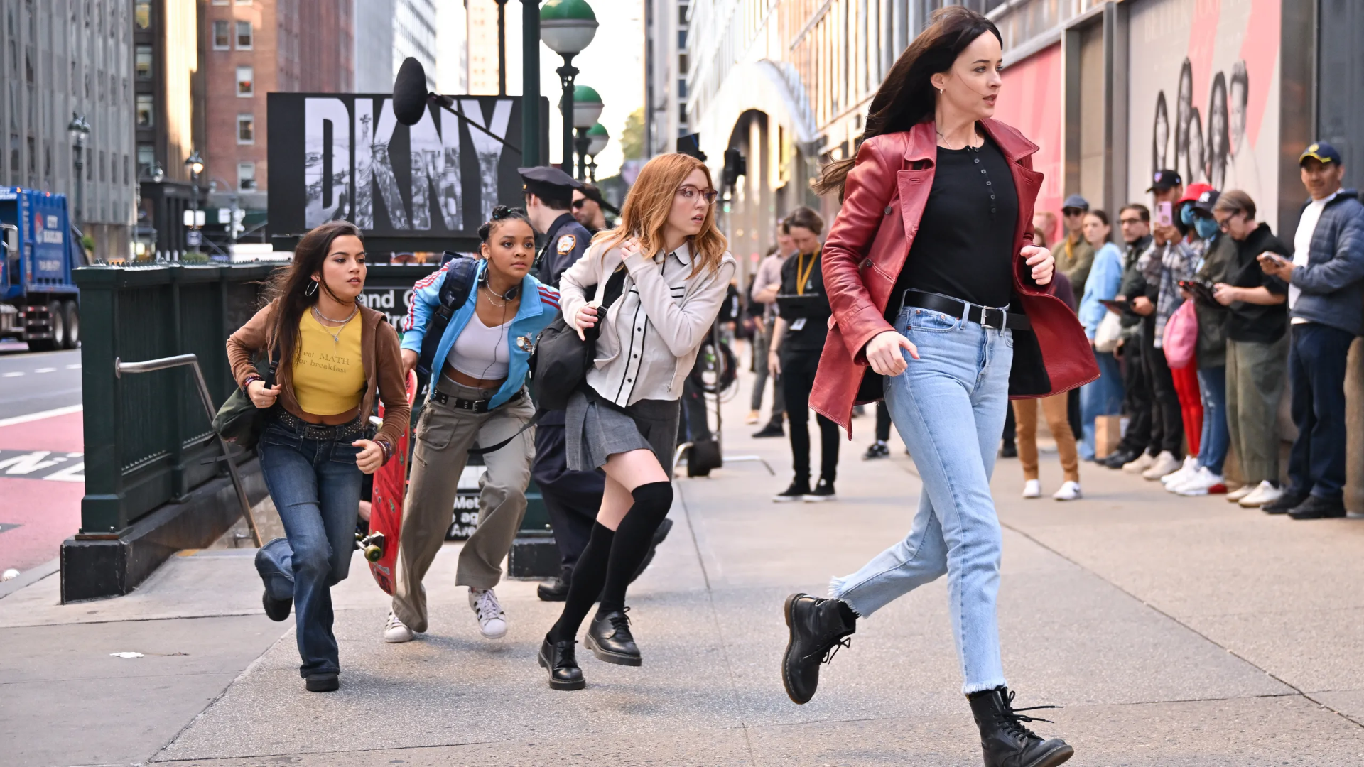 A high-definition desktop wallpaper from the movie *Madame Web*, featuring characters running in an urban setting, showcasing action and dynamic movement.