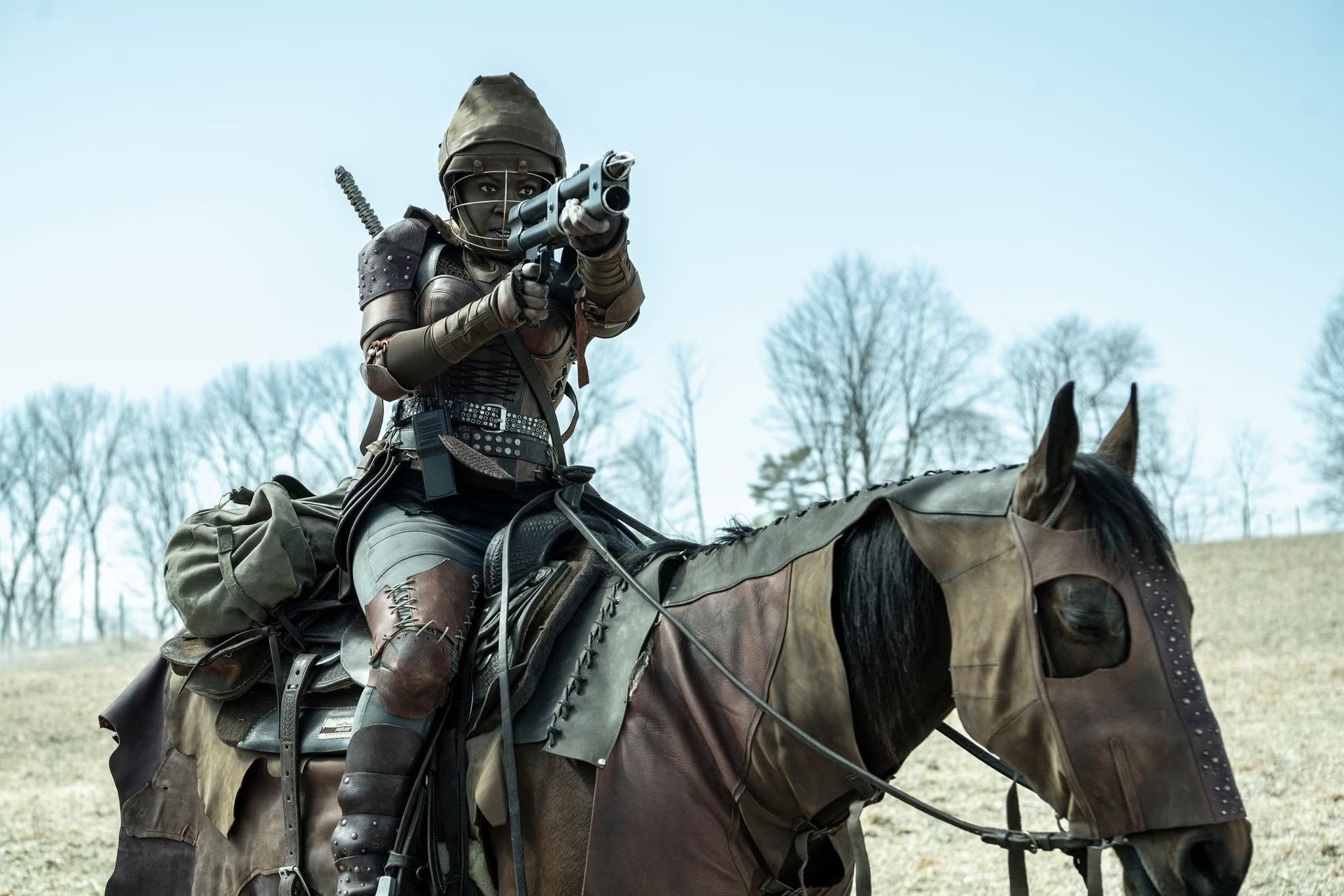 HD desktop wallpaper from The Walking Dead: The Ones Who Live featuring a character on horseback aiming a gun.