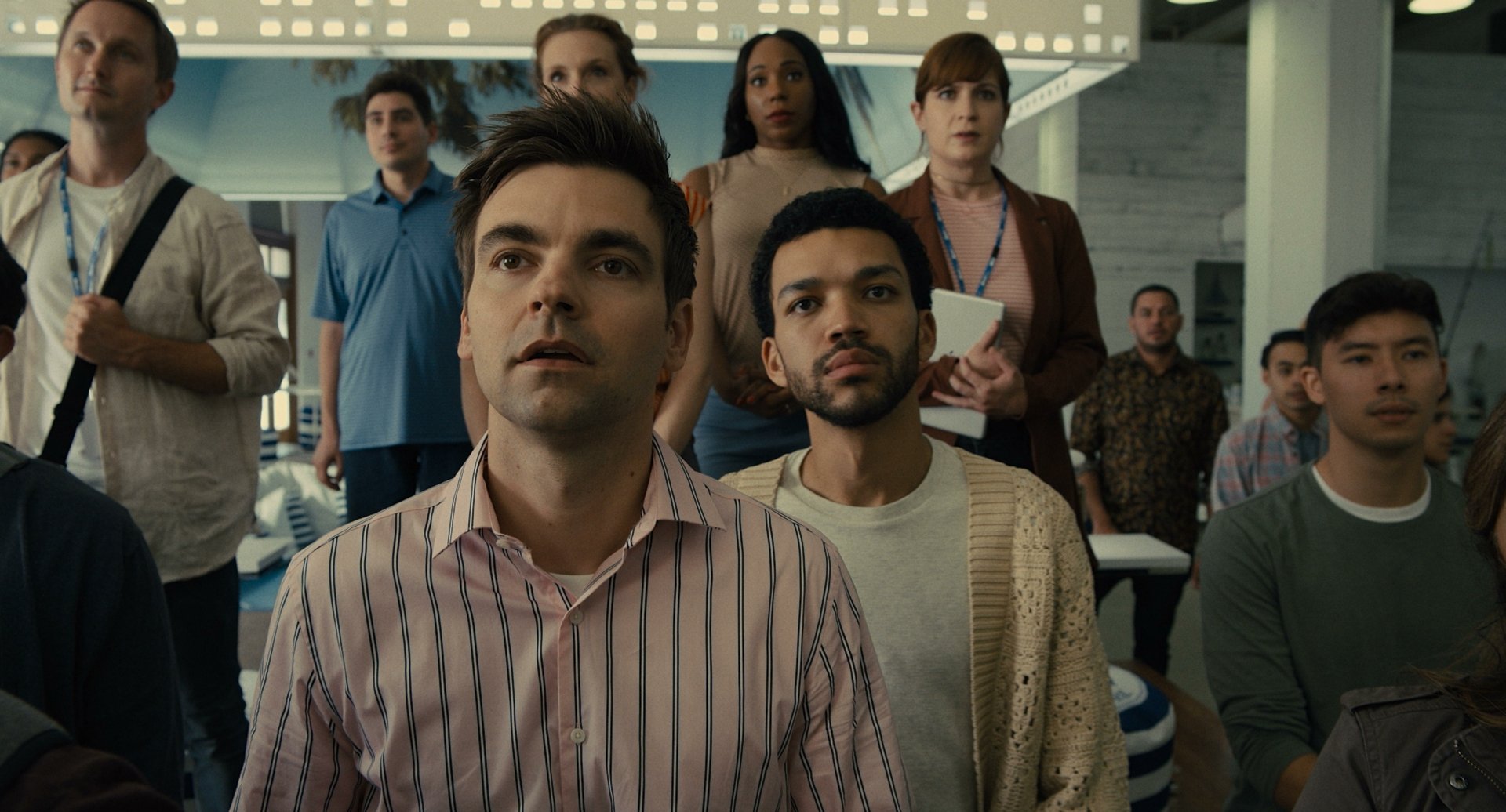 Group of diverse actors in a scene from a TV show for a high-definition desktop wallpaper themed around The American Society of Magical Negroes.