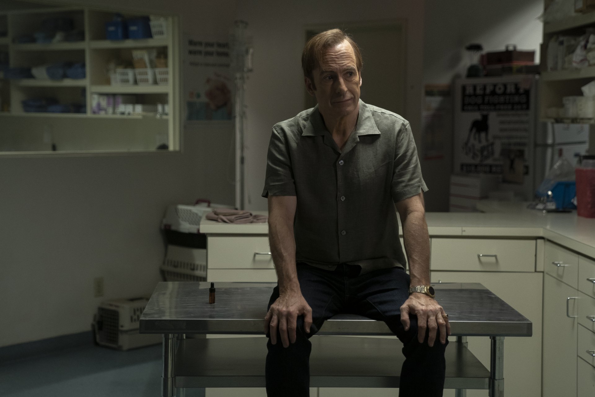 Saul Goodman, portrayed by Bob Odenkirk, sits contemplatively in a dimly lit room, encapsulating the intense atmosphere of *Better Call Saul*. A striking HD wallpaper for fans.