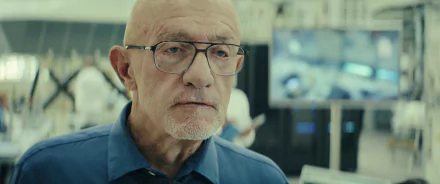Close-up of Jonathan Banks in a scene from the TV show Constellation (2024), set against a backdrop of a high-tech environment, serving as an HD desktop wallpaper.