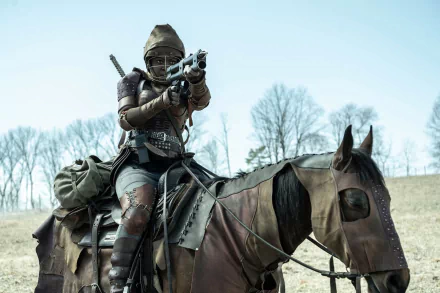 HD desktop wallpaper from The Walking Dead: The Ones Who Live featuring a character on horseback aiming a gun.