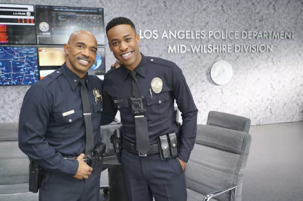 HD wallpaper featuring two smiling police officers from the TV show The Rookie, set in the Los Angeles Police Department Mid-Wilshire Division.