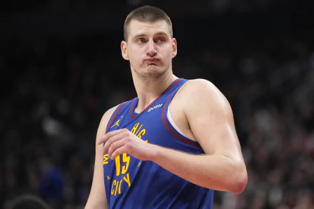 Nikola Jokić of the Denver Nuggets poses confidently in this HD desktop wallpaper, showcasing his dynamic presence on the court.