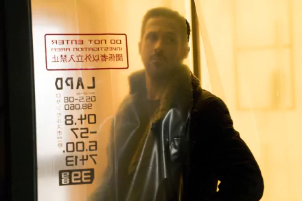HD wallpaper of Officer K from Blade Runner 2049 with Ryan Gosling standing by a window with neon writing.