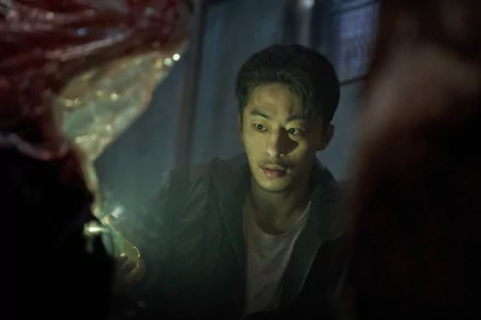 HD desktop wallpaper from the TV Show Parasyte: The Grey featuring a tense scene with a male character gazing intently.