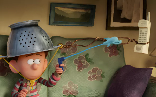 HD wallpaper featuring an animated character from the movie 'Orion and the Dark' wearing a colander as a helmet and holding a slingshot, with a cozy room background.