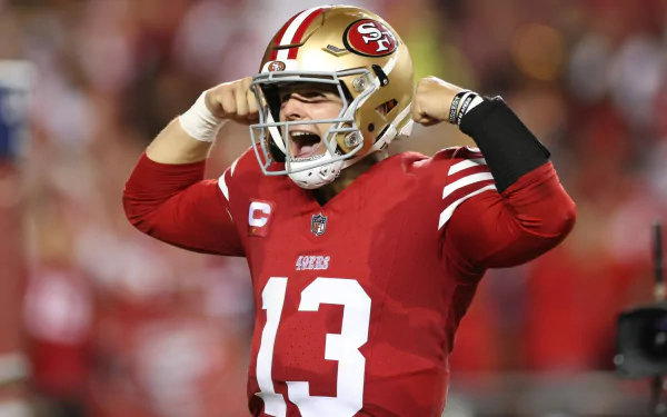 HD wallpaper of a San Francisco 49ers quarterback in action on the football field, capturing the intensity of the NFL and Super Bowl spirit.