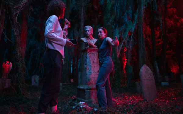 HD desktop wallpaper from the movie Lisa Frankenstein featuring characters in a neon-lit graveyard scene.