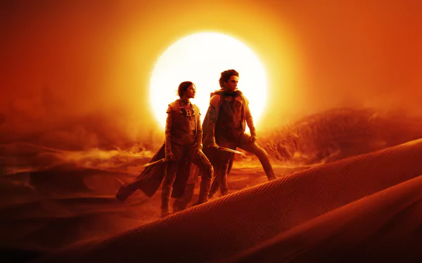HD desktop wallpaper featuring two characters from Dune: Part Two walking in a desert landscape with a looming sun in the background, symbolizing the epic sci-fi saga.
