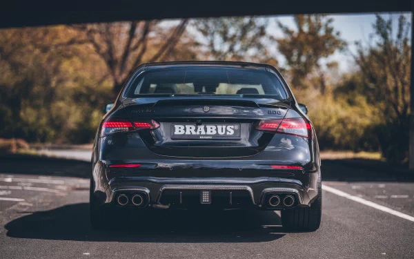 Brabus 800 E63 car showcased as an HD desktop wallpaper, featuring the powerful vehicle's rear view parked under a bridge.