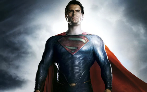 HD PC desktop wallpaper featuring the Man of Steel standing confidently with his iconic suit and red cape against a dramatic cloudy sky background.