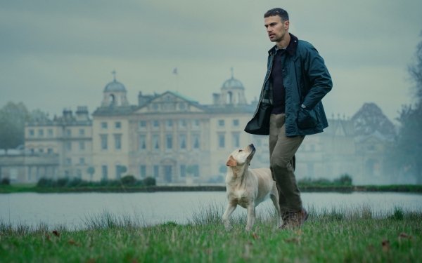Actor from The Gentlemen (2024) TV show walking with a dog in front of an elegant manor house, available as HD desktop wallpaper and background.